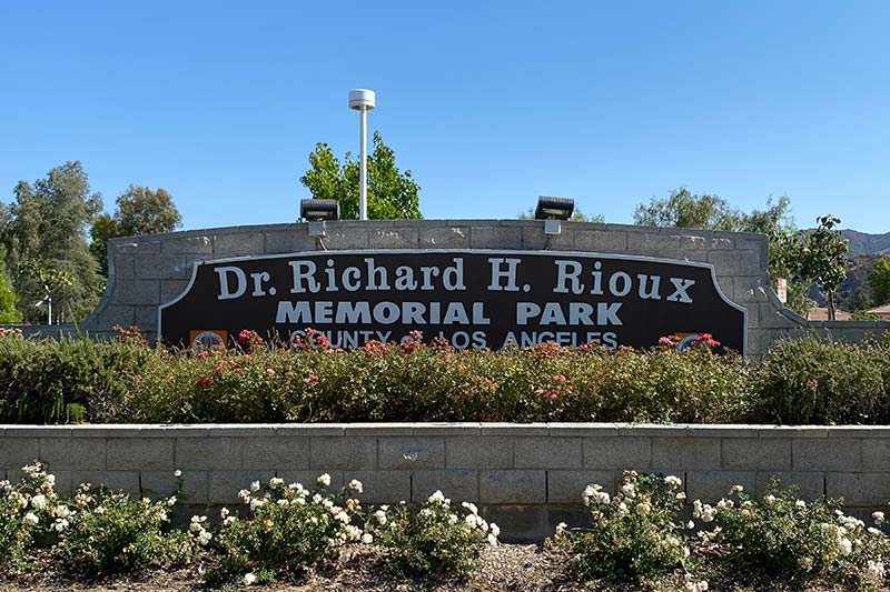 Dr Richard H Rioux Memorial Park Sign