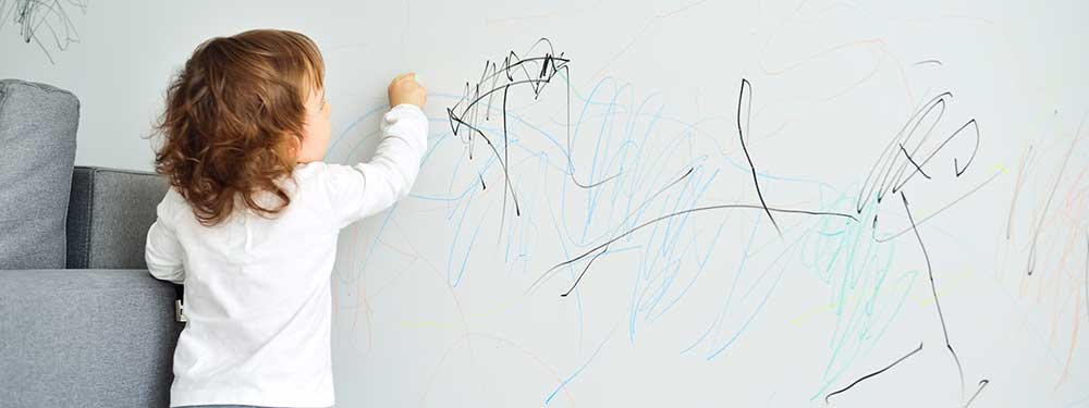 Child Drawing on Wall